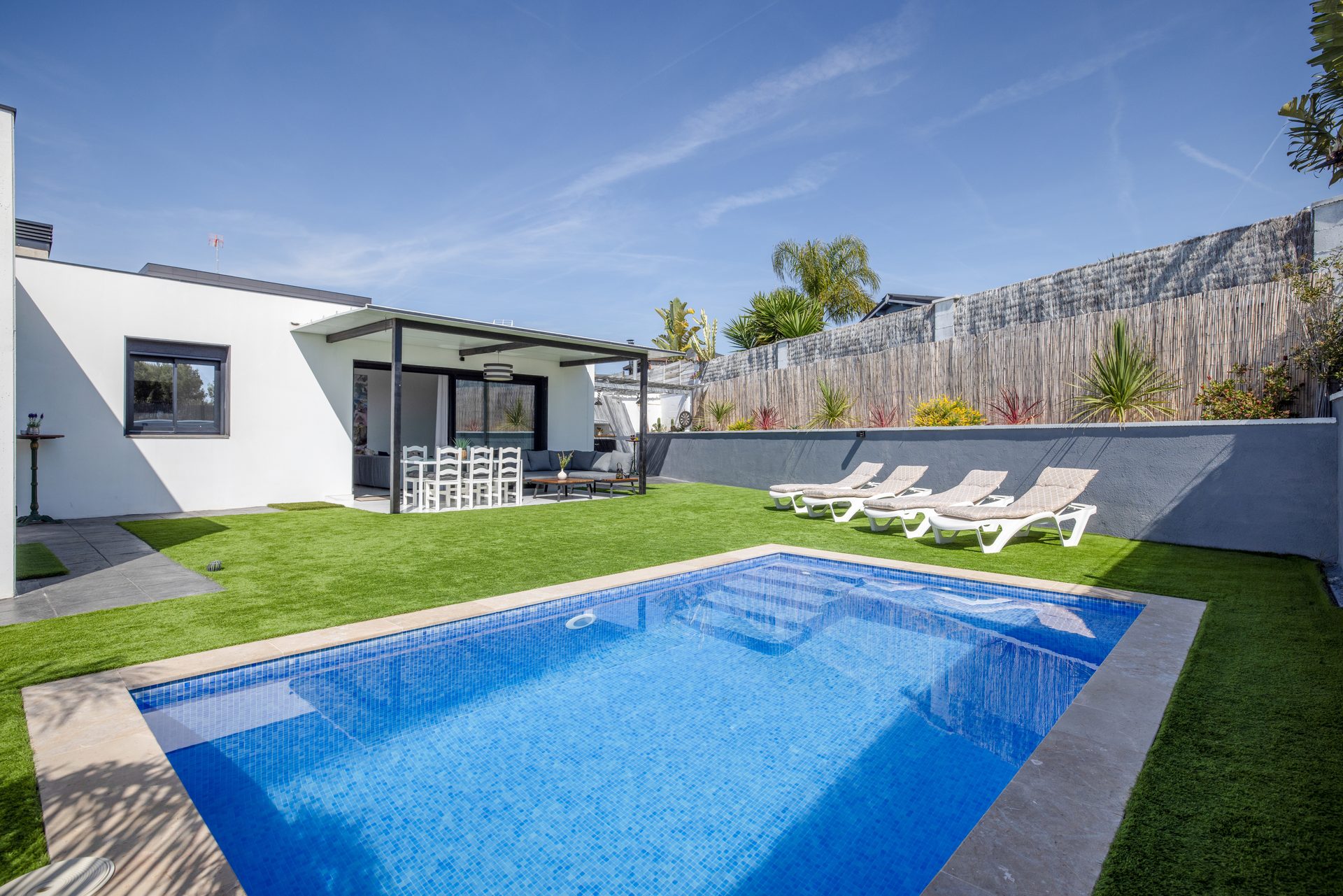 Piscina privada con jardín, tumbonas y terraza cubierta en La Villa del Roc, Roda de Berà, Costa Daurada
